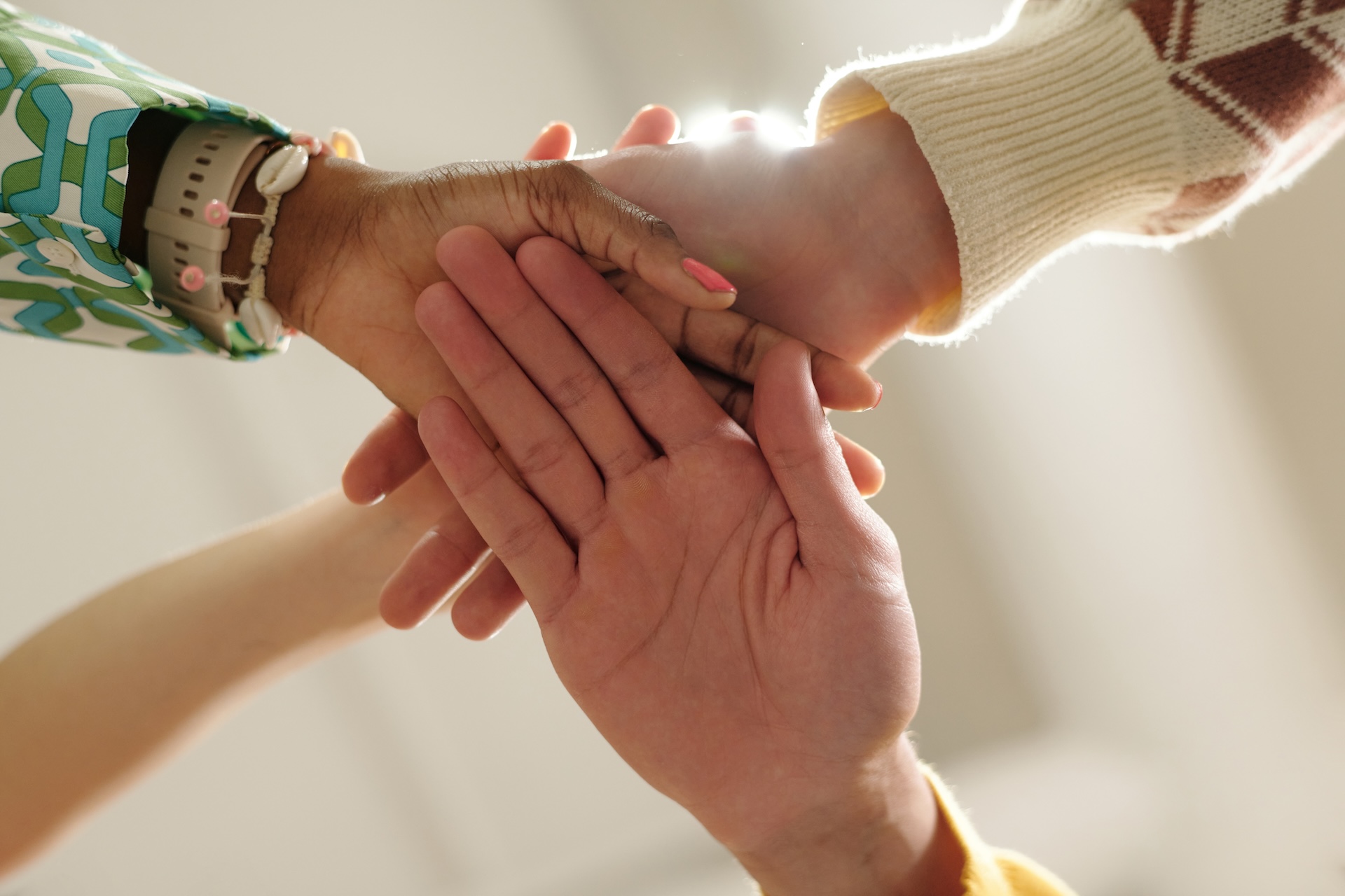 joining-hands-of-young-adult-women-and-men-collabo-2025-10-27-21-44-59-utc